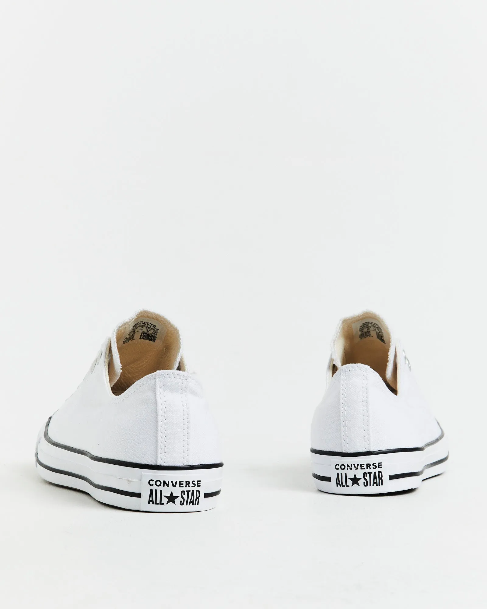 Chuck Taylor All Star Slip On Sneakers In White/Black