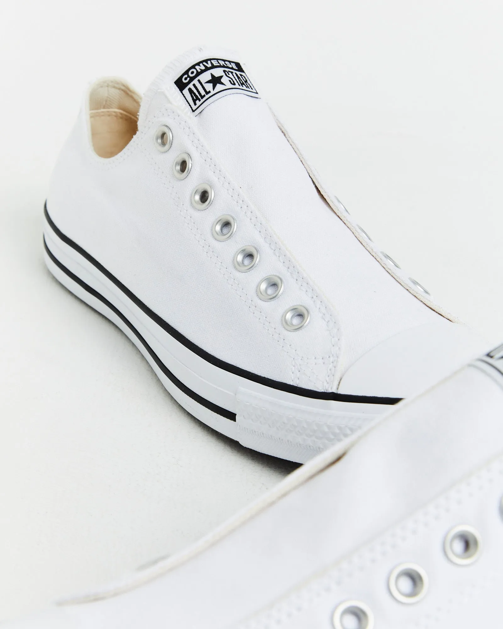 Chuck Taylor All Star Slip On Sneakers In White/Black